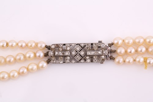 Lot 98 - A three-row cultured pearls necklace with an...