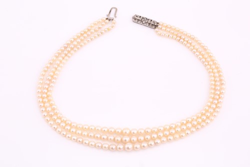 Lot A three-row cultured pearls necklace with an...