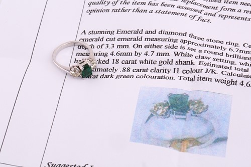 Lot 107 - A diamond and emerald three stone ring,...