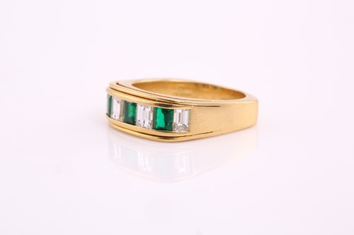 Lot 83 - A diamond and emerald half eternity ring,...