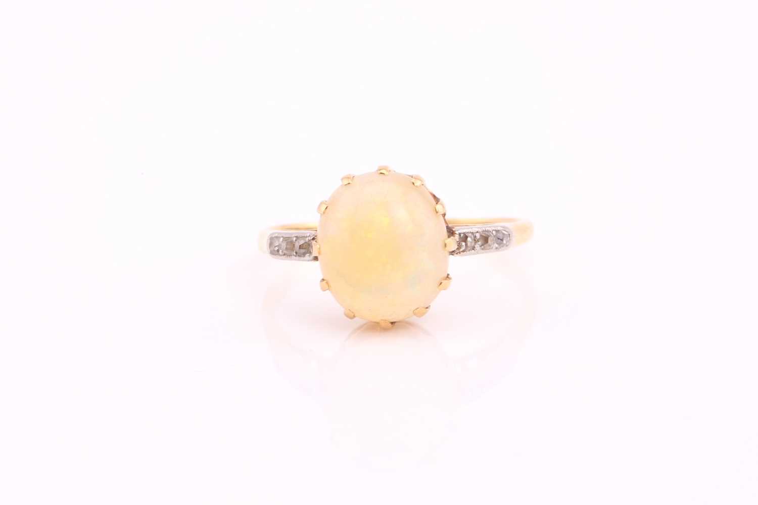Lot 246 - An opal ring with diamonds, comprises an oval...