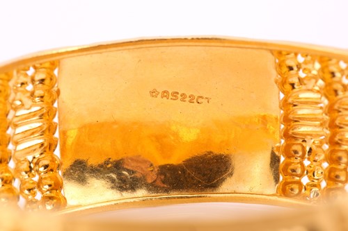 Lot 35 - A yellow metal bangle, decorated with pierced,...