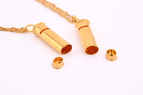 Lot 136 - Two pendants on yellow precious metal chains,...