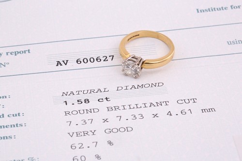 Lot 60 - An 18ct gold diamond solitaire ring, with a...