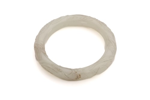 Lot 68 - A Chinese jade bangle, 20th century, carved in...