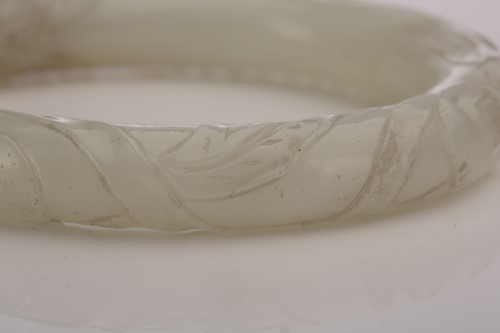 Lot 68 - A Chinese jade bangle, 20th century, carved in...