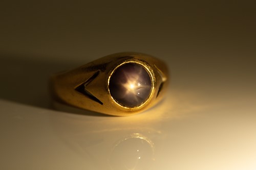 Lot 276 - A star sapphire gypsy ring, featuring a round...