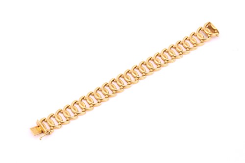 Lot 178 - A wide fancy link bracelet, with textured oval...
