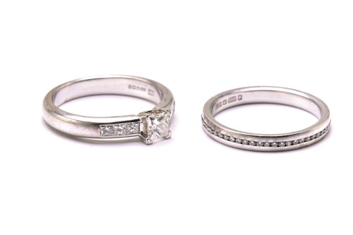 Lot 206 - A diamond engagement ring and an eternity ring...