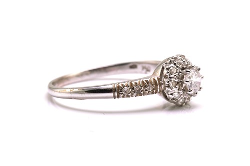 Lot 33 - A diamond entourage ring in white precious...