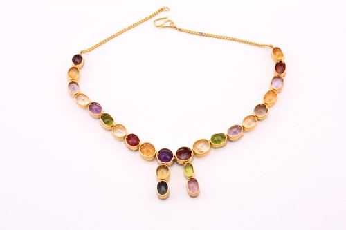 Lot 156 - A multi gem-set rivière necklace in gilt metal,...