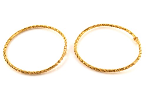 Lot 148 - A pair of tension bangles and a Poh Heng...