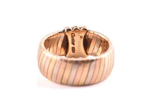 Lot 134 - Cartier - Tri-coloured tubogas band ring, with...