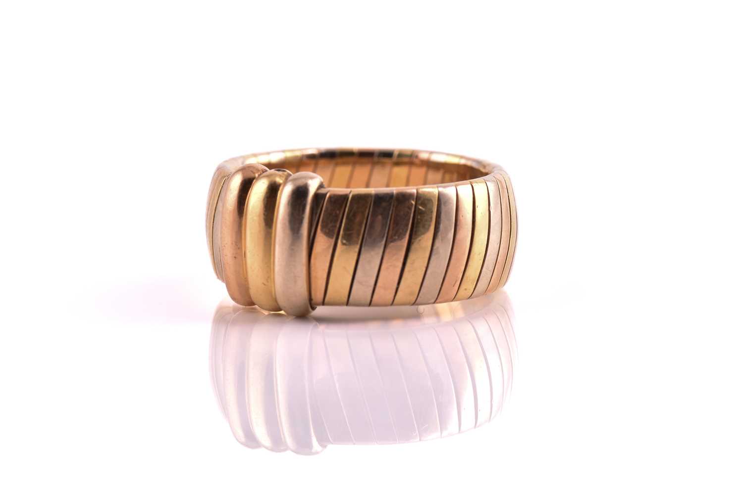 Lot 134 - Cartier - Tri-coloured tubogas band ring, with...