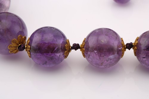 Lot 266 - An amethyst bead necklace and a similar single...