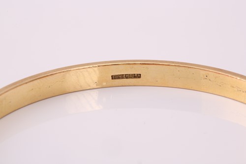 Lot 282 - A yellow precious metal closed bangle, with a...