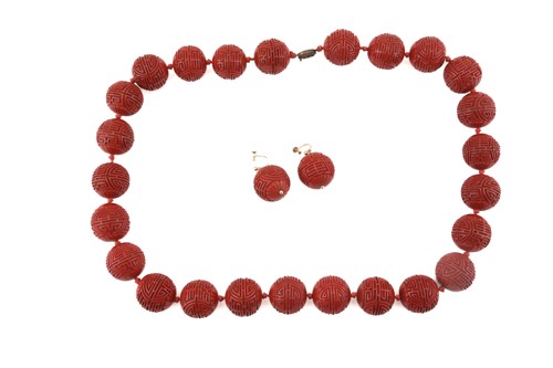 Lot 3 - A Chinese lacquer carved bead necklace and...