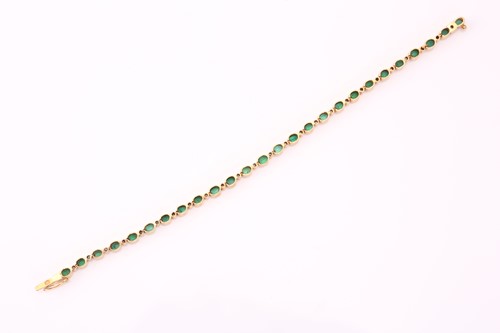 Lot 239 - An emerald and diamond bracelet in yellow...