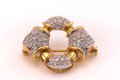 Lot 168 - A diamond buckle brooch, with four sections...