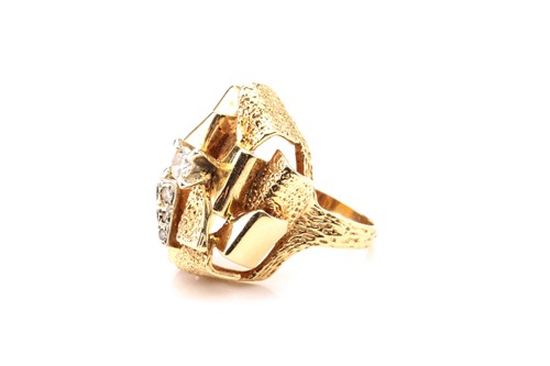 Lot 78 - A modernist yellow metal and diamond ring,...