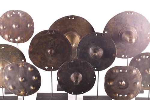 Lot 184 - A collection of twelve bronze shield bosses,...