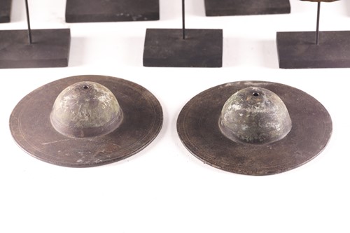 Lot 184 - A collection of twelve bronze shield bosses,...