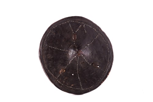 Lot 107 - Ethnographica comprising a hide parrying...