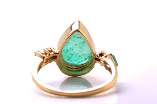Lot 79 - An emerald and diamond 18ct gold ring, centred...