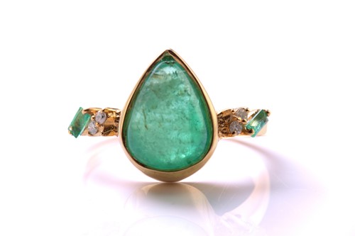Lot An emerald and diamond 18ct gold ring, centred...