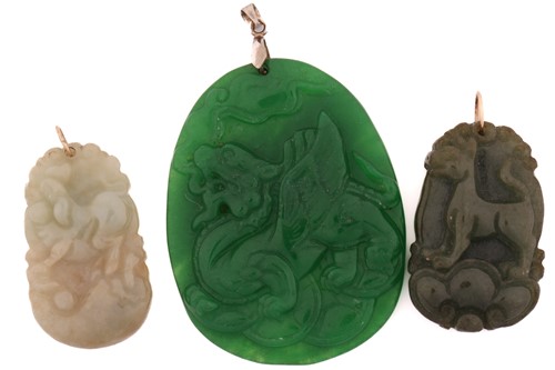Lot 185 - Three modern Chinese carved hardstone pendants;...
