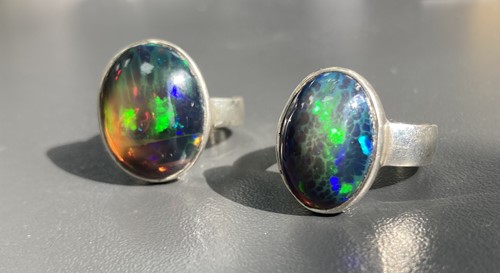 Lot 58 - Two black opal rings; First consists of an...