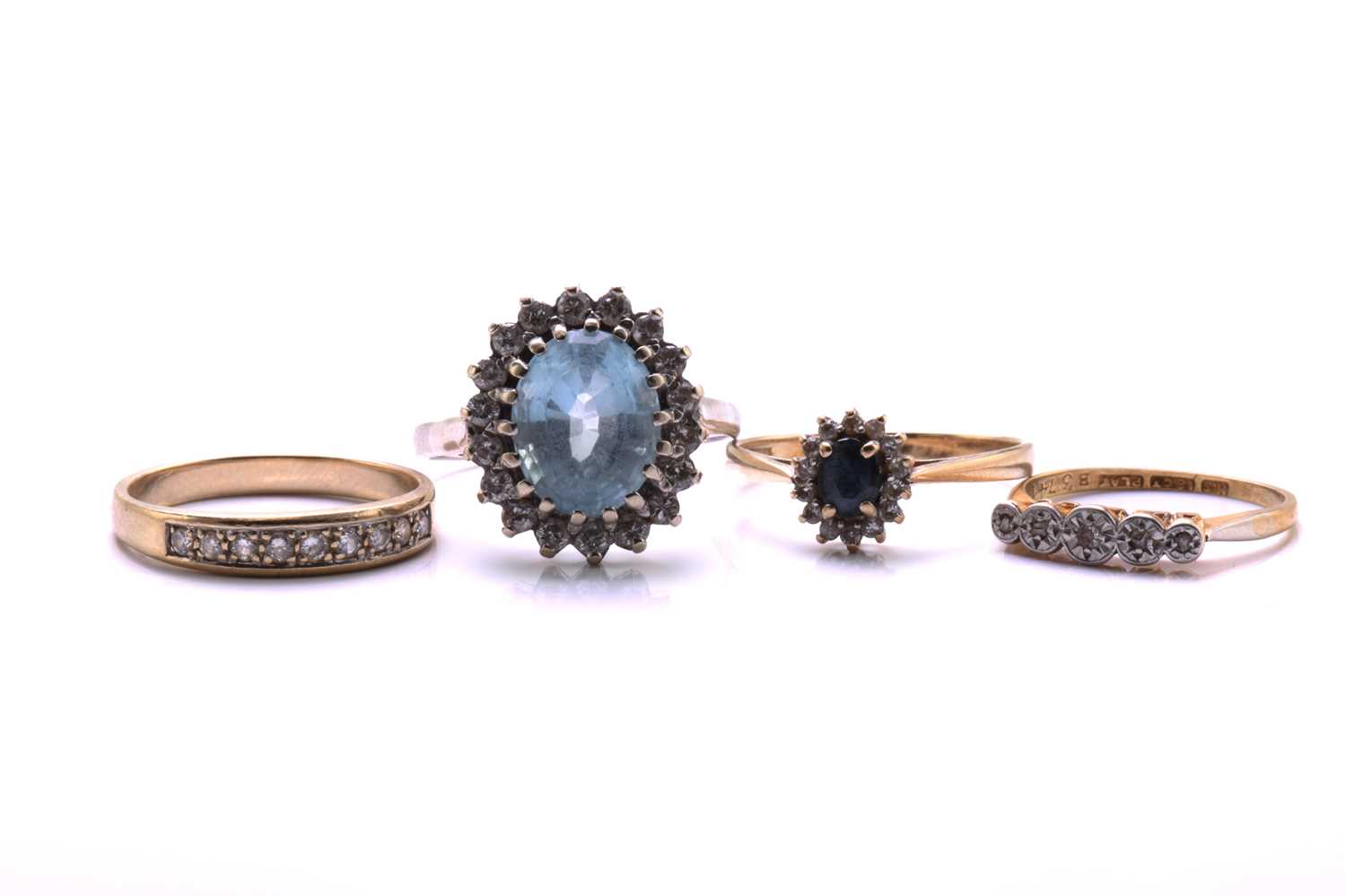 Lot 154 - Four gem-set rings, to include an 18ct gold...