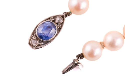 Lot 114 - A single row pearl necklace with gem-set clasp,...