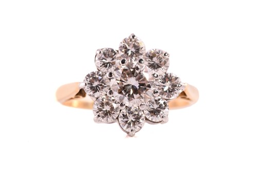 Lot A diamond cluster ring, featuring a round...