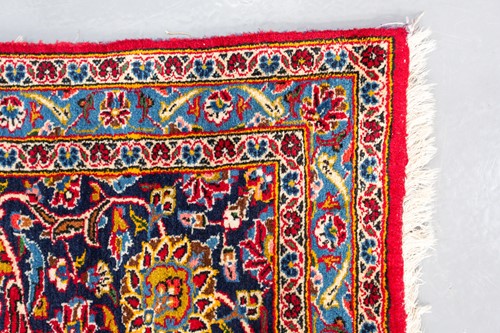 Lot 275 - A "Lacquer Red" ground room size Kashan carpet,...