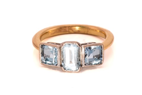 Lot 149 - A three-stone aquamarine ring, centred with a...