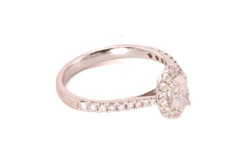 Lot 122 - An oval diamond entourage ring in 18ct gold,...