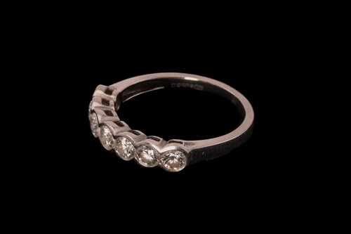 Lot 215 - A diamond half eternity ring in platinum,...