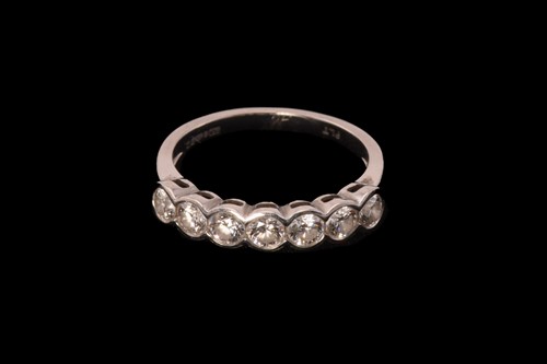 Lot 215 - A diamond half eternity ring in platinum,...