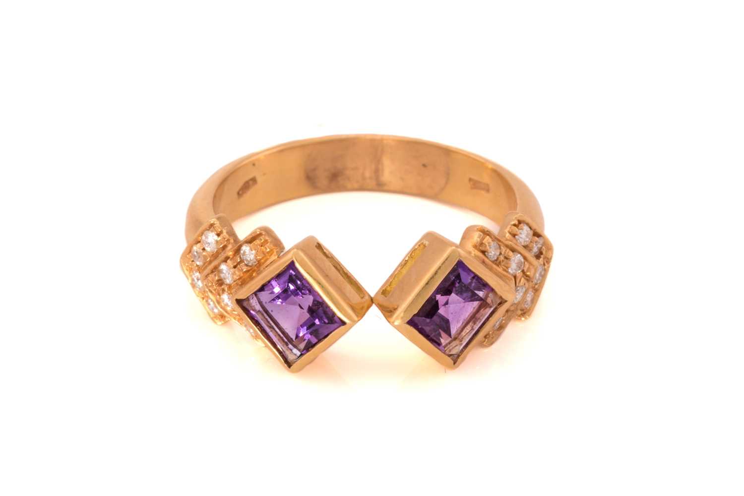 Lot 41 - An amethyst and diamond dress ring, featuring...