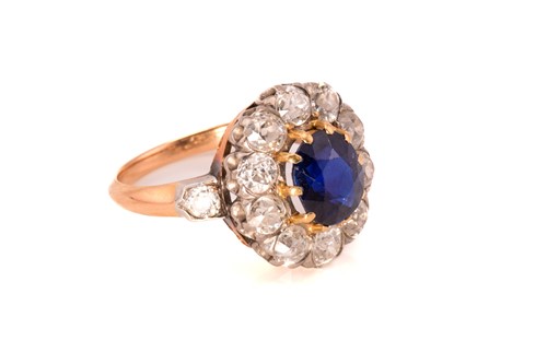 Lot 39 - A sapphire and diamond halo ring, comprises a...