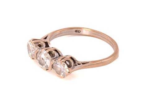 Lot 226 - A three-stone diamond ring in 18ct gold,...