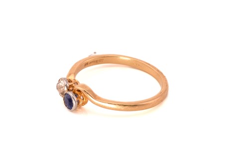 Lot 130 - A sapphire and diamond crossover ring, with a...
