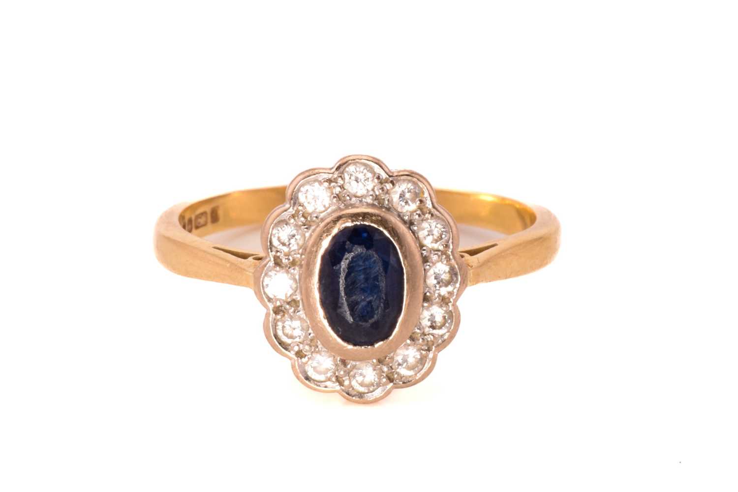 Lot 66 - A sapphire and diamond cluster ring in 18ct...