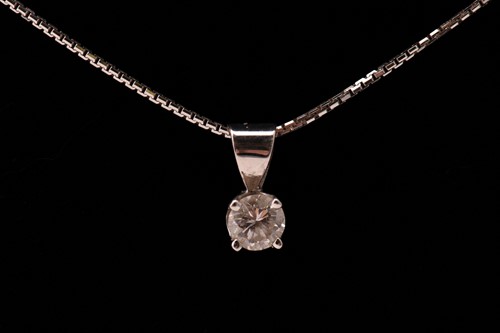 Lot 129 - A diamond and 18ct gold pendant on chain,...