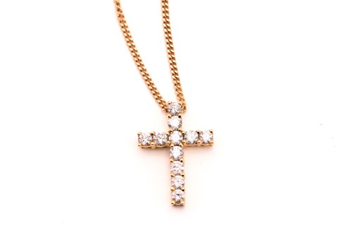 Lot 89 - An 18ct gold and diamond-set cross pendant on...