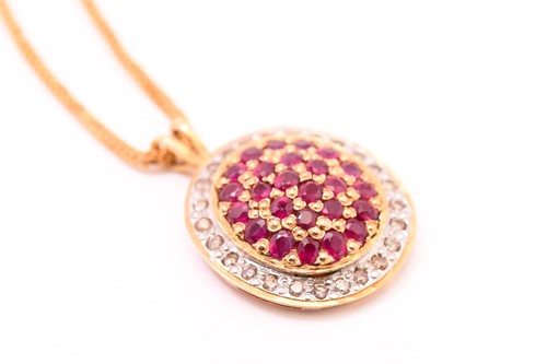 Lot 110 - A ruby and diamond cluster pendant on chain,...