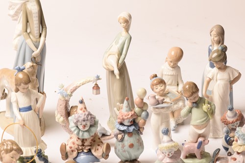 Lot 228 - A large collection of Lladro and Nao figurines,...