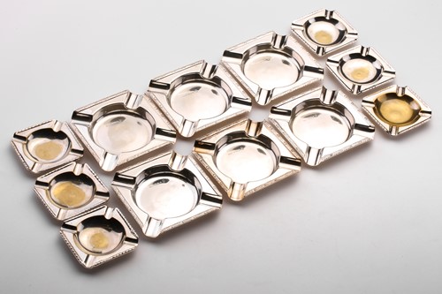 Lot 390 - A set of six square silver ashtrays with cast...