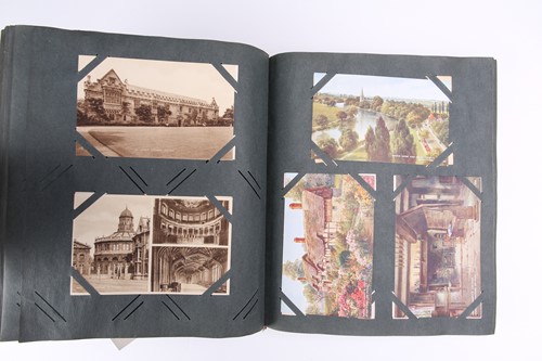 Lot 197 - A vintage postcard album containing many...